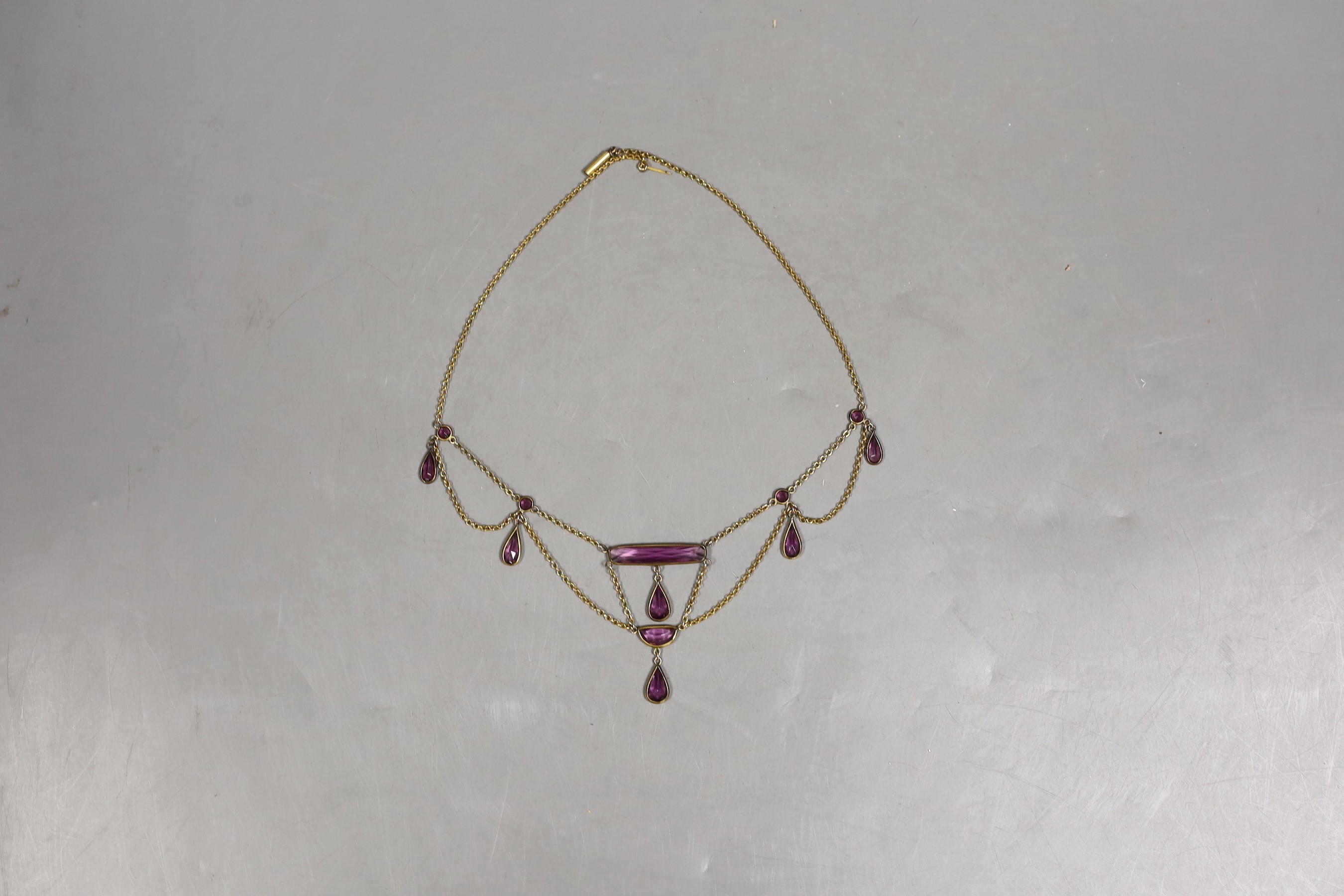 An early 20th century gilt metal and amethyst paste set drop fringe necklace, approx. 46cm.